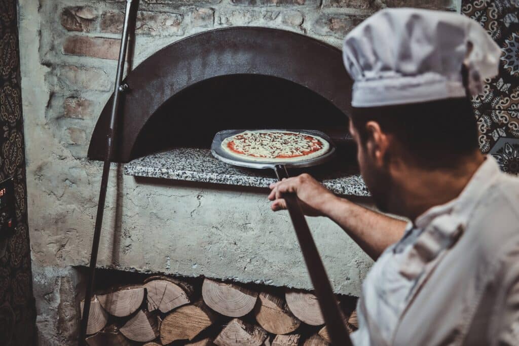 1682582053 pizza oven using special giant spatula - Can You Bake Pizza On A Silicone Mat? - ZSR